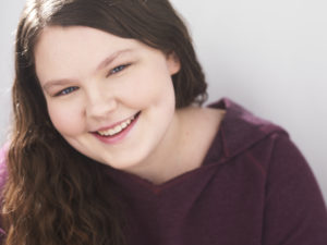 Headshot smiling with purple shirt